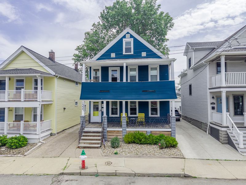 Front of the blue house with its covered porch