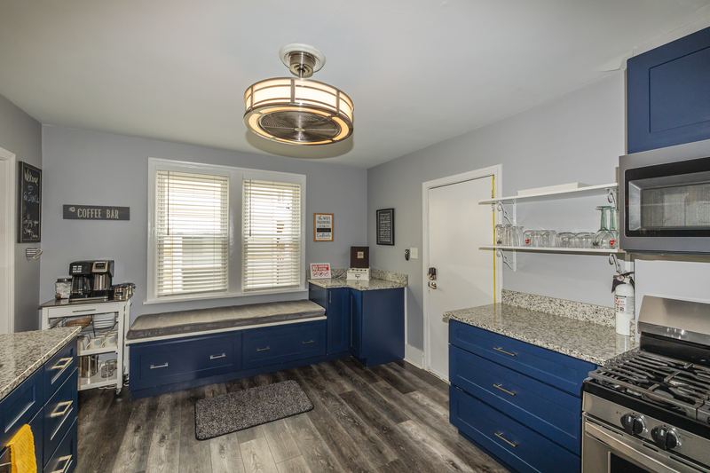 Kitchen from the other side showing the gas range and window seat